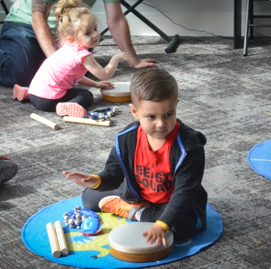 kid banging on drum