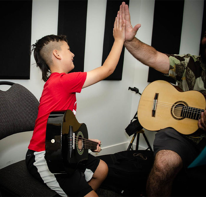 kid learning guitar