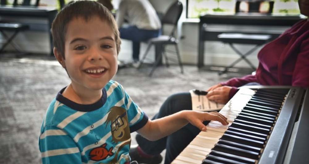 boy smiling at piano