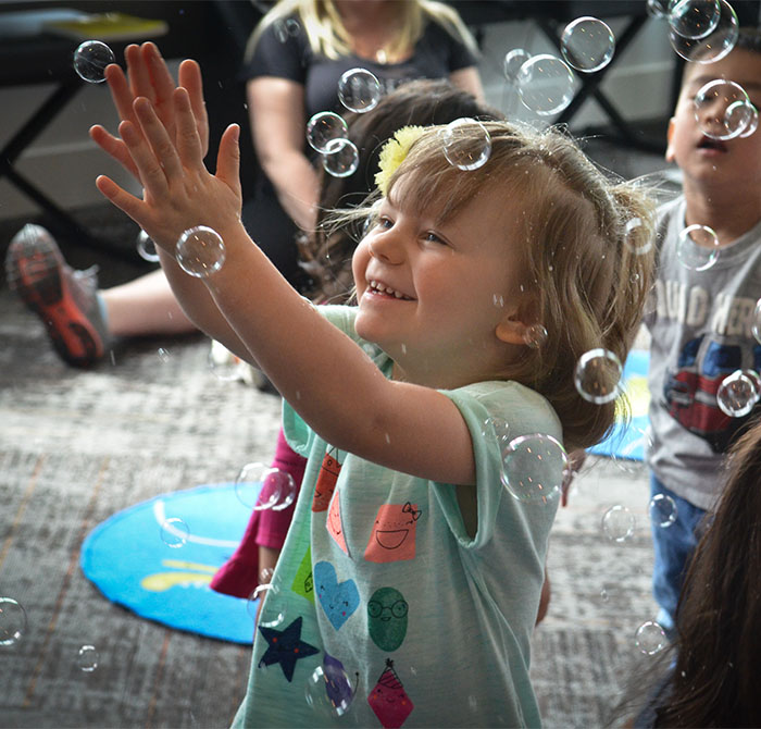 happy girl dancing in bubbles