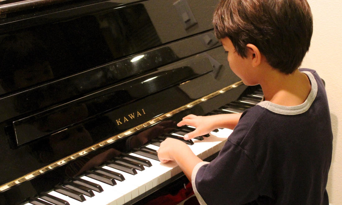 boy learning the piano