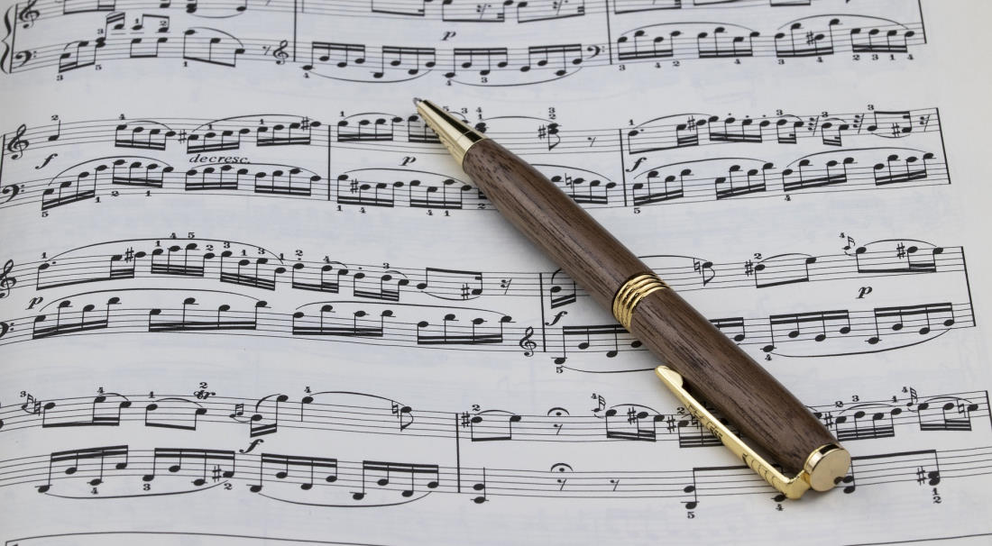 piano sheet music with pen