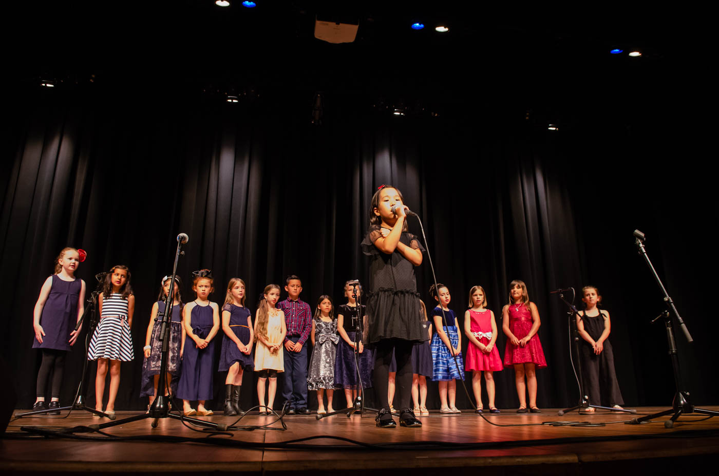 kids on stage for vocal performance 