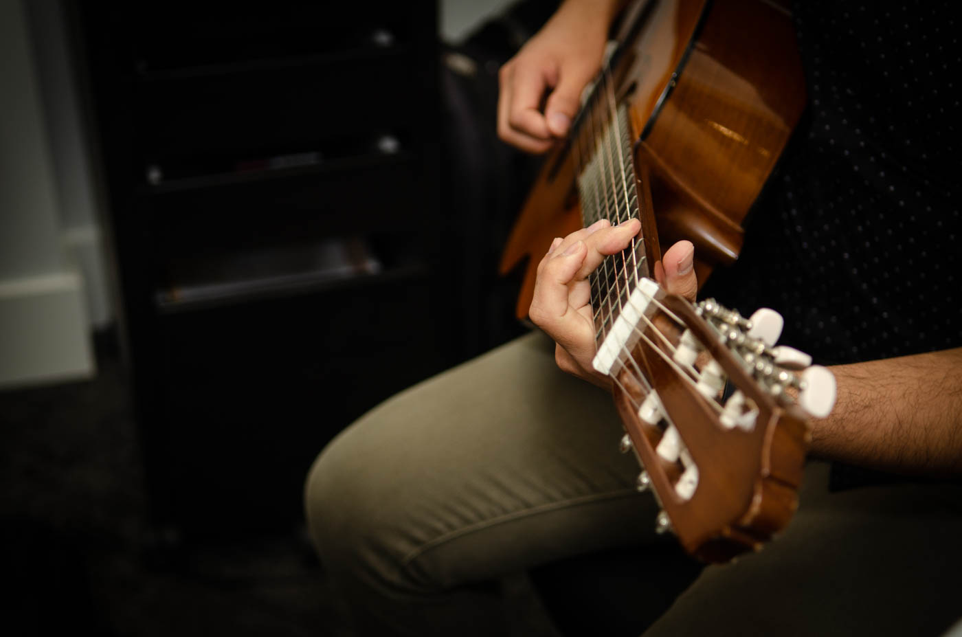 man strumming on acoustic guitar