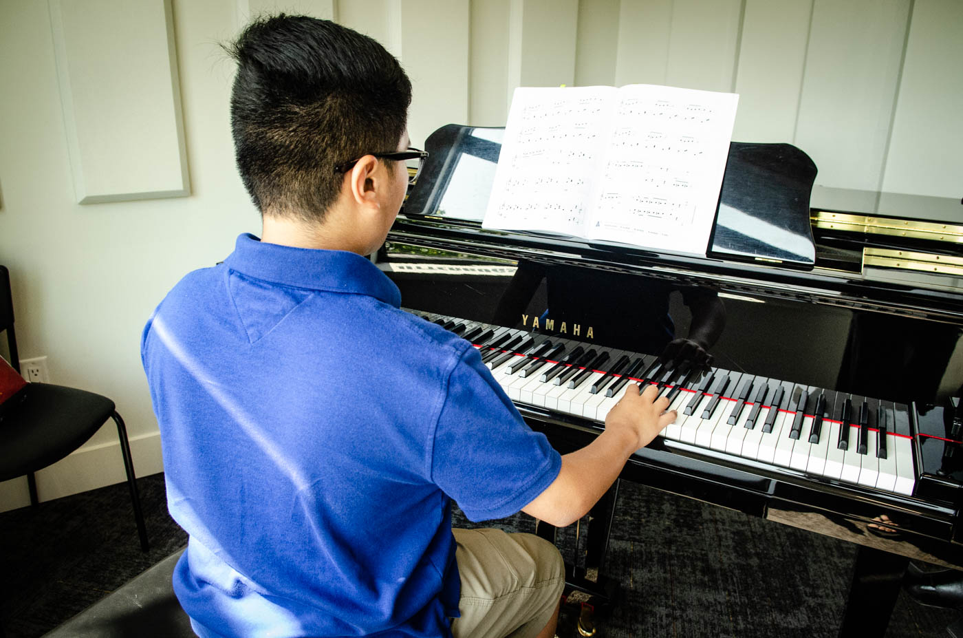 Young man rehearsing on piano