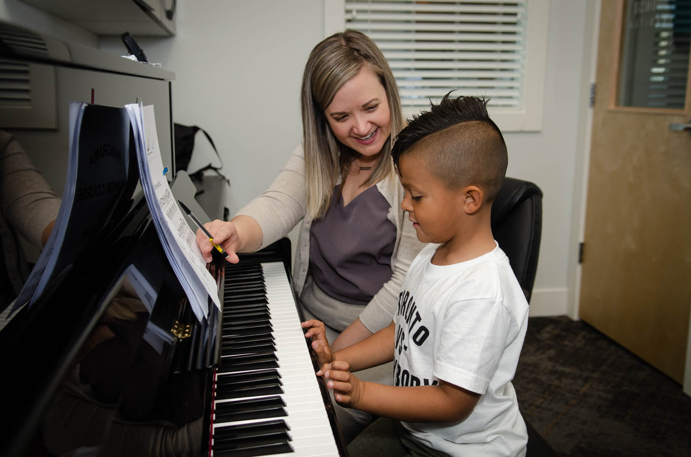 kid learning song on piano