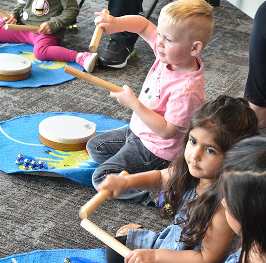 kids playing with percussion instruments