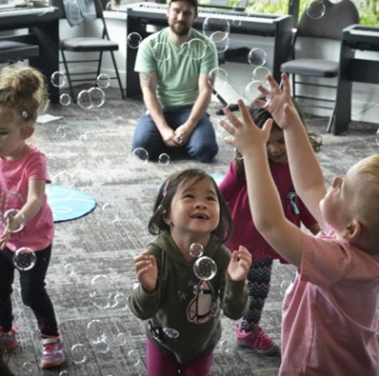 kids playing with bubbles