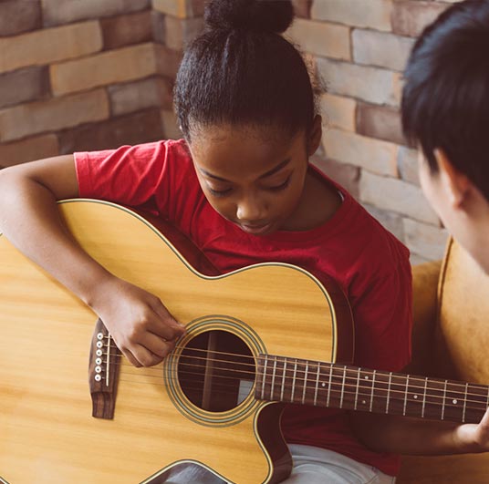 girl learning guitar