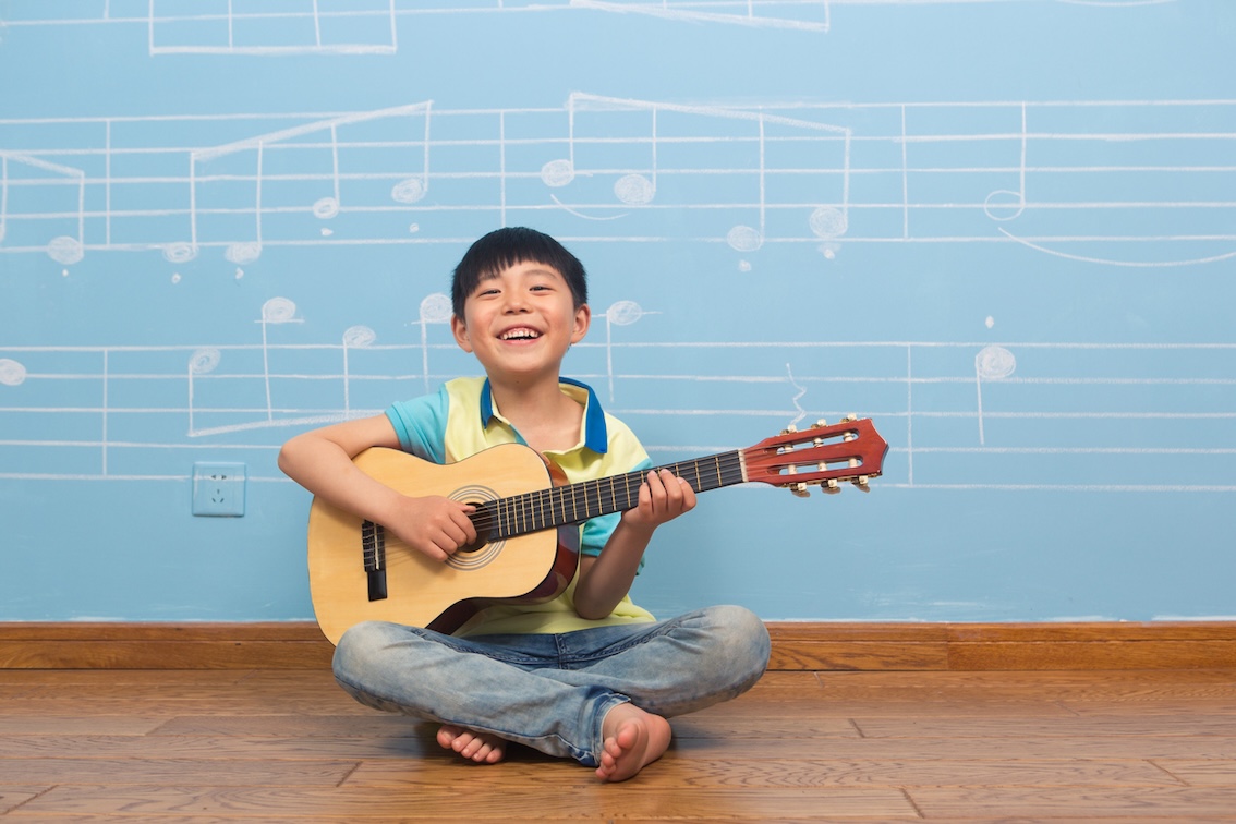 smiling boy with a guitar