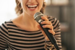 woman singing in microphone