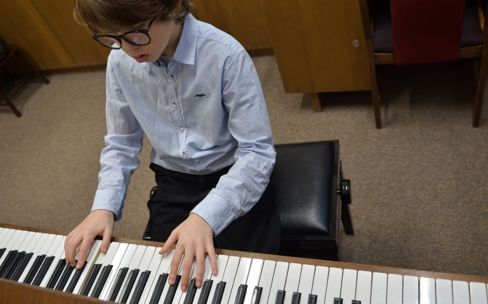 boy playing piano in exam